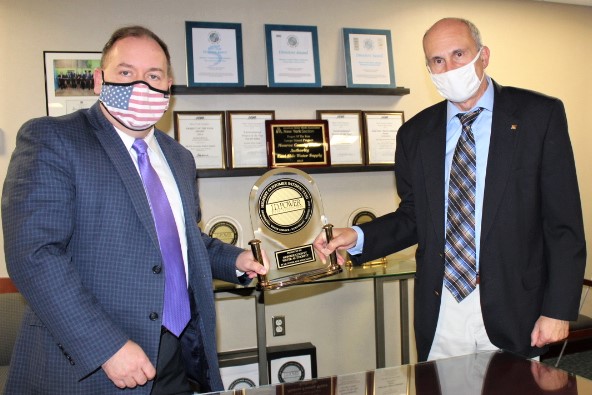 Board Chair Scott Nasca and Executive Director Nick Noce show off J.D. Power Award